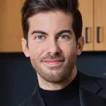 Luis D. Ortiz smiling at a real estate event