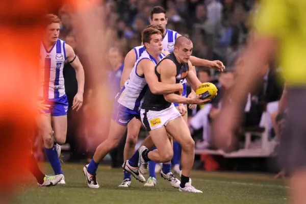 Brad McKenzie playing for North Melbourne in AFL