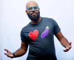 Akeem Woods performing comedy on stage with confident expression