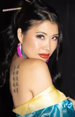 Jiaoying Summers performing stand-up comedy on stage