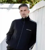 Keiran Lee posing confidently in a modern lifestyle setting