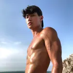 Alex James posing in stylish attire, representing his OnlyFans and influencer brand.