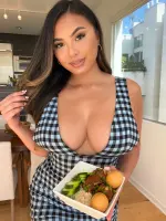 Linda Vo smiling in a modern kitchen setting, presenting a dish from her cooking series
