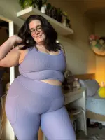 Luna Lewis TV smiling in a cozy setting, showcasing her confident and body-positive style