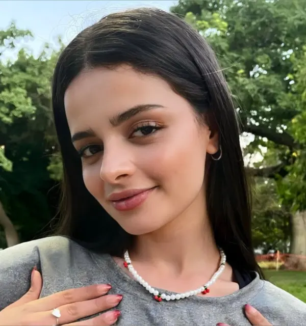 Millie Mi posing in soft lighting before a dance tutorial