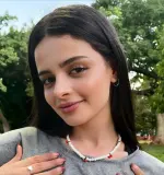 Millie Mi posing in soft lighting before a dance tutorial