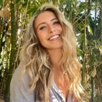 Cocoyogi TV posing in a natural outdoor setting, blending yoga and travel aesthetics