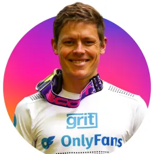 Stefan Garlicki riding a mountain bike downhill, wearing racing gear with a confident expression.