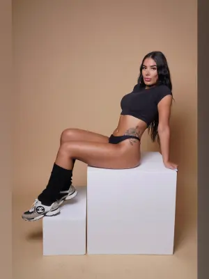 Alyssa, The Cocktail Queen, posing with a vibrant cocktail in hand, showcasing her mixology skills