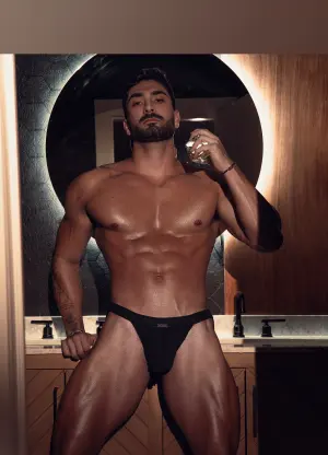 Zayn Dom posing in a modern lifestyle setting, reflecting his fitness and fashion aesthetic