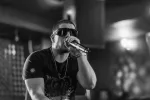 Famoe performing live on stage with microphone