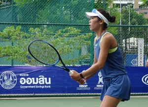 Patcharin Cheapchandej playing tennis on court